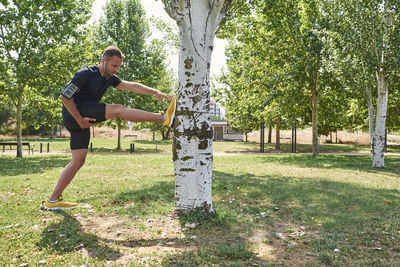 Man stretching after exercise in a park.