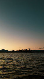 Scenic view of sea against clear sky during sunset