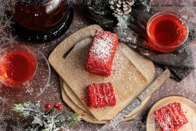 Strawberry piece of cake and red fruit tea, with winter decorations