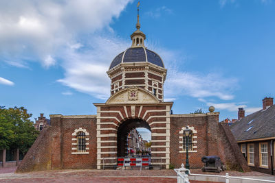 Low angle view of building against cloudy sky