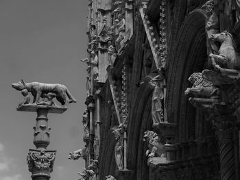 Low angle view of statue against temple