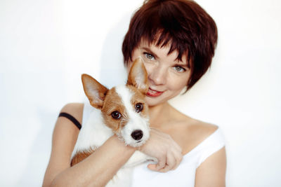 Woman portrait in white tank top with puppy white background