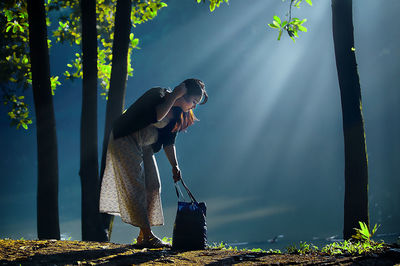 Side view of woman standing against the sky