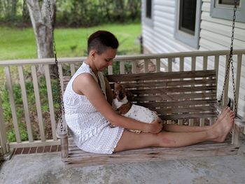 Man with dog sitting outdoors