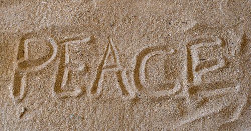 Full frame shot of text on sand