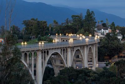 Colorado street bridge in pasadena at dusk with lights on