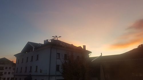 Low angle view of buildings against sky during sunset