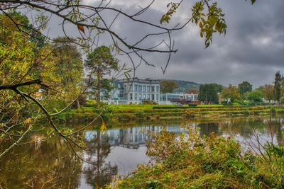 Scenic view of lake by trees against sky