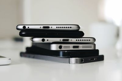 Close-up of stacked mobile phones on table