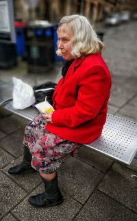 Woman holding umbrella while standing outdoors