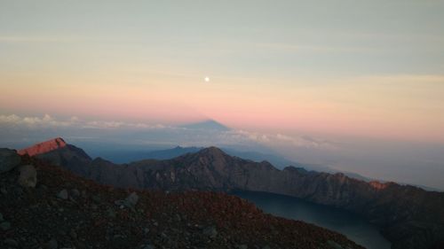 Scenic view of mountains against sky at sunset