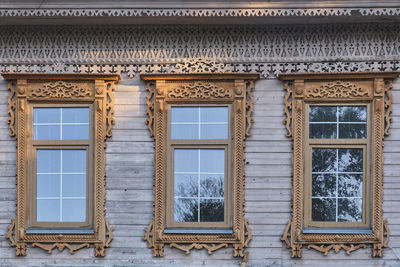 Three typical windows with carved wood platbands, merchant house of 19th century,yelabuga, russia