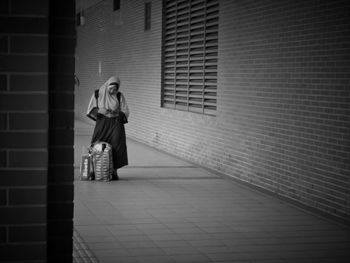 Woman standing against wall