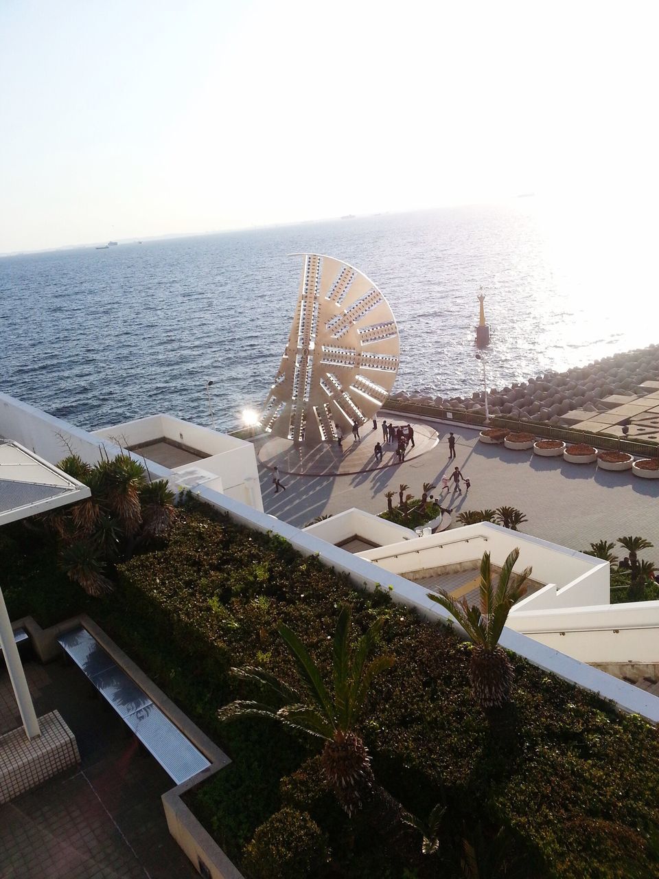 sea, water, horizon over water, clear sky, beach, tranquility, tranquil scene, nature, shore, high angle view, sunlight, scenics, beauty in nature, day, sky, outdoors, built structure, plant, no people, sand