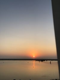 Scenic view of sea against clear sky during sunset