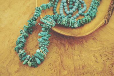 Close-up of bead necklace on wooden table