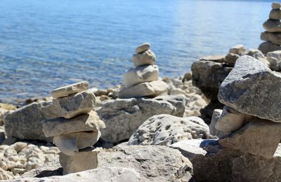 Stack of rocks on beach against sky