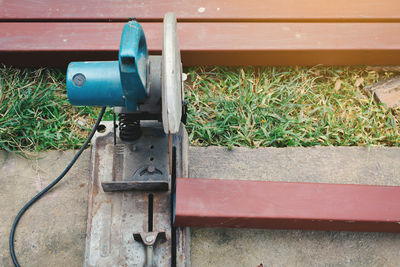 High angle view of circular saw by metal poles on field