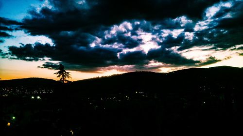 Scenic view of silhouette landscape against sky at sunset