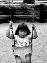 Boy swinging at playground