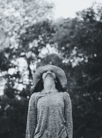 Woman standing against trees