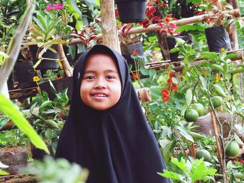 Portrait of smiling girl against plants