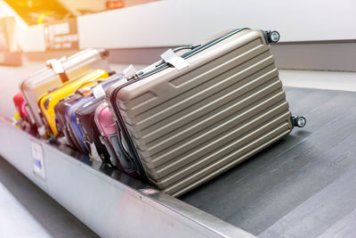 High angle view of luggage on conveyor belt at airport