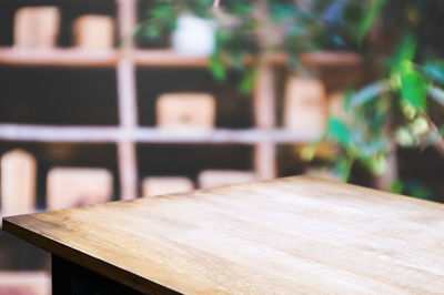 Close-up of wooden bench on table