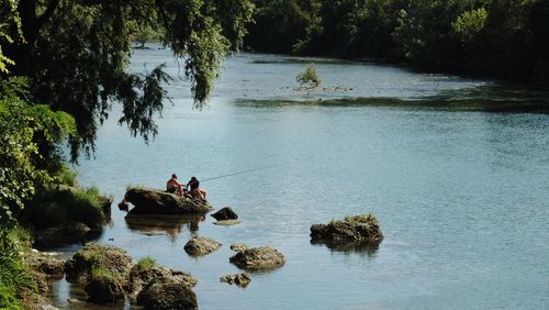 People standing by lake