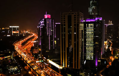 High angle view of illuminated buildings in city at night