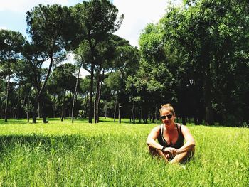 Portrait of young man relaxing on field