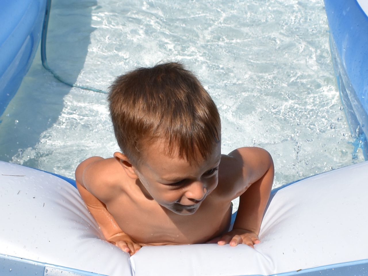 child, childhood, boys, water, one person, leisure activity, males, men, real people, day, shirtless, lifestyles, portrait, nature, headshot, swimming pool, pool, outdoors, innocence