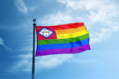 Low angle view of flags against blue sky