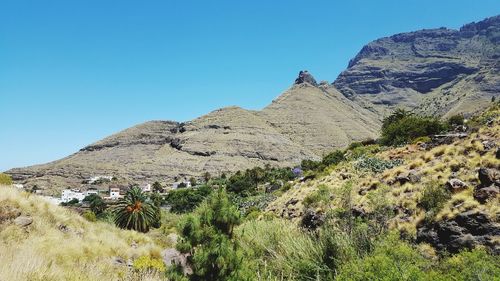 Scenic view of mountains against clear blue sky