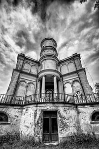 Low angle view of building against cloudy sky