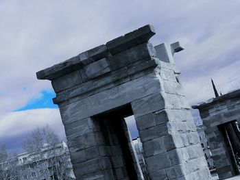 Low angle view of historical building against cloudy sky