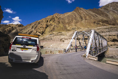 Cars on road against mountain range