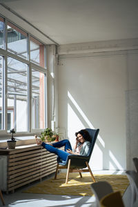 Mature businesswoman sitting on chair in office