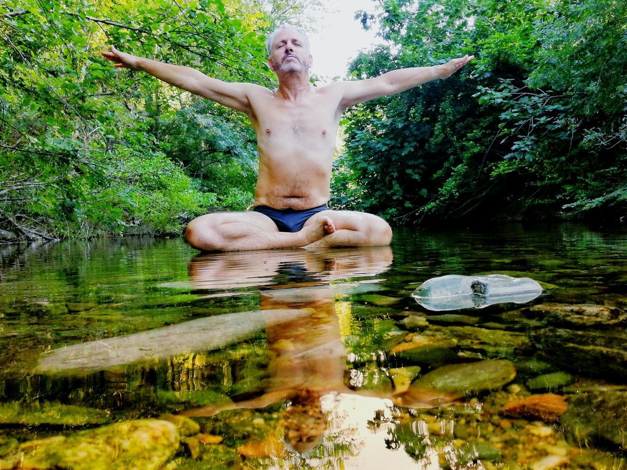 REFLECTION OF MAN IN LAKE