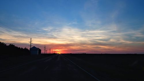 Silhouette of road against sky during sunset