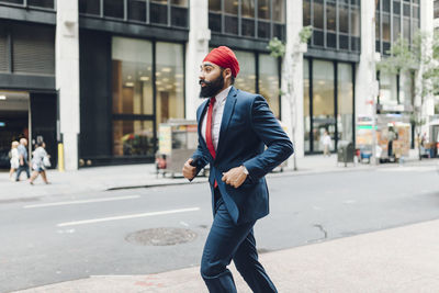 Indian businessman in manhattan running in the street