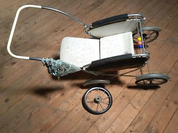 High angle view of damaged wheelchair on floorboard