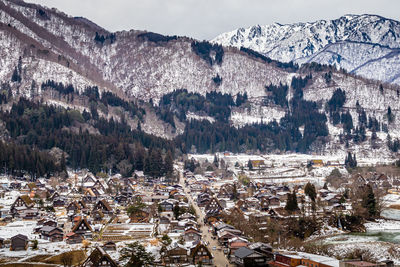 High angle view of townscape and mountains during winter