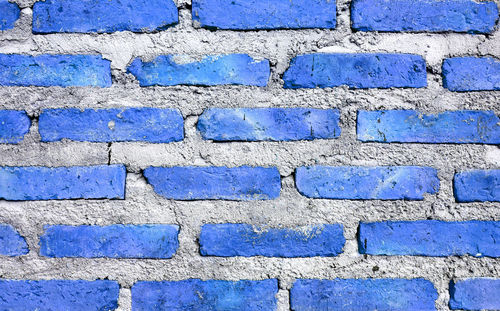 Front view of cobalt blue with gray colored grunge brick wall for abstract backdrop