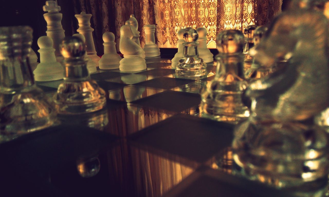 CLOSE-UP OF CHESS PIECES ON TABLE AT HOME