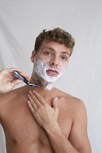 Portrait of young man in bathroom