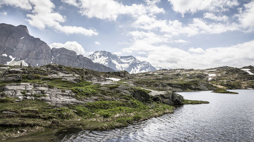 Scenic view of lake and mountains against sky