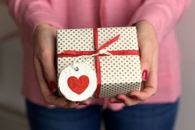 Midsection of woman holding gift