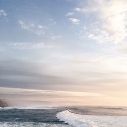 Scenic view of sea against cloudy sky