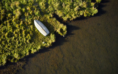 Solitary wooden boat lying on river shore